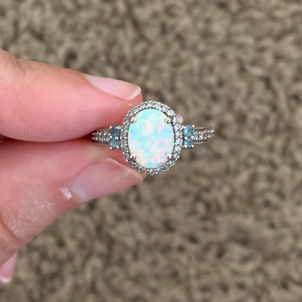Opal ring, side stones are blue topaz and diamonds